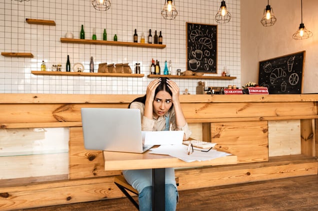 stressed-cafe-owner-looking-at-laptop(1)